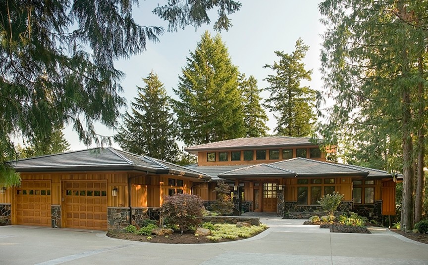 Inspiration for a large and brown rustic two floor house exterior in Seattle with wood cladding.