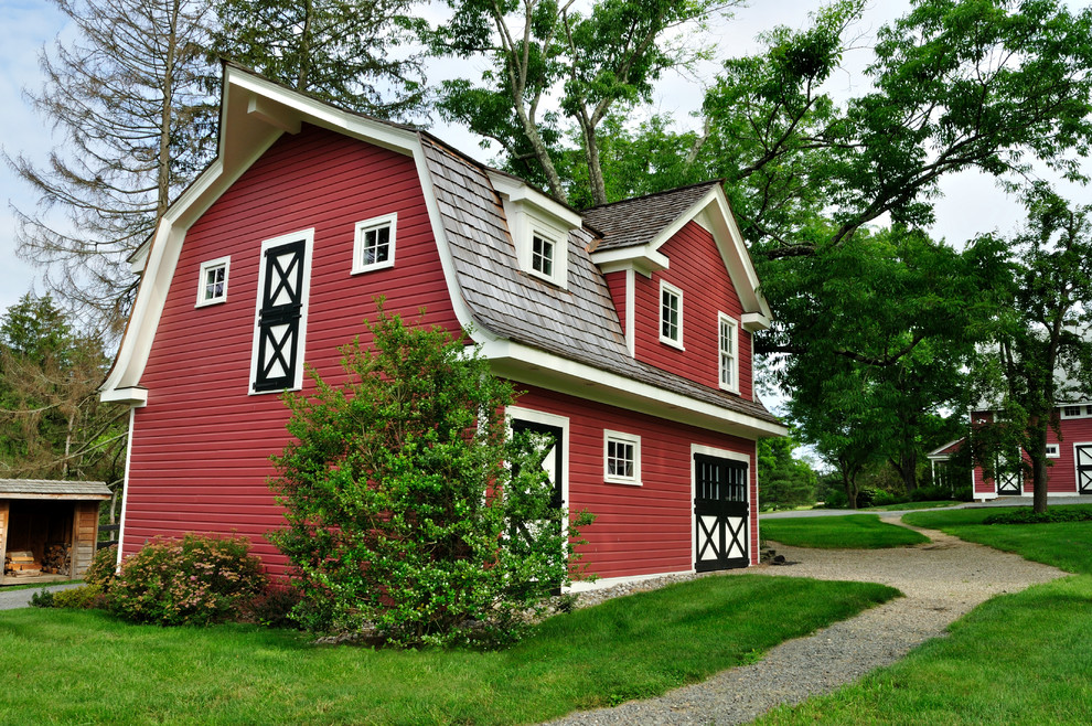Photo of a small and red traditional two floor house exterior in New York with wood cladding and a mansard roof.