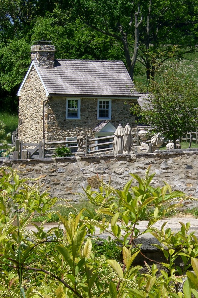 This is an example of a country two floor house exterior in Philadelphia with stone cladding.