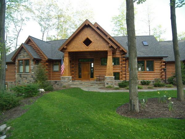 This is an example of a medium sized and brown rustic two floor house exterior in Other with a pitched roof and mixed cladding.