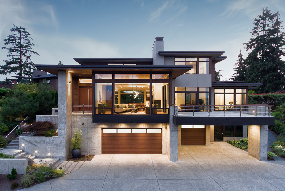 Idée de décoration pour une grande façade de maison grise minimaliste en béton à deux étages et plus avec un toit plat.