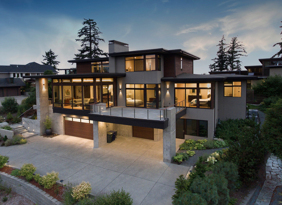 Exemple d'une grande façade de maison grise moderne en béton à deux étages et plus avec un toit plat.