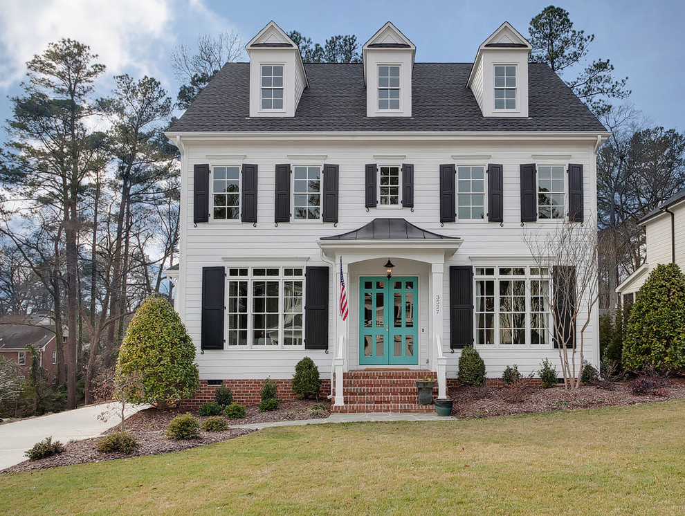 Example of a classic white two-story exterior home design in Raleigh
