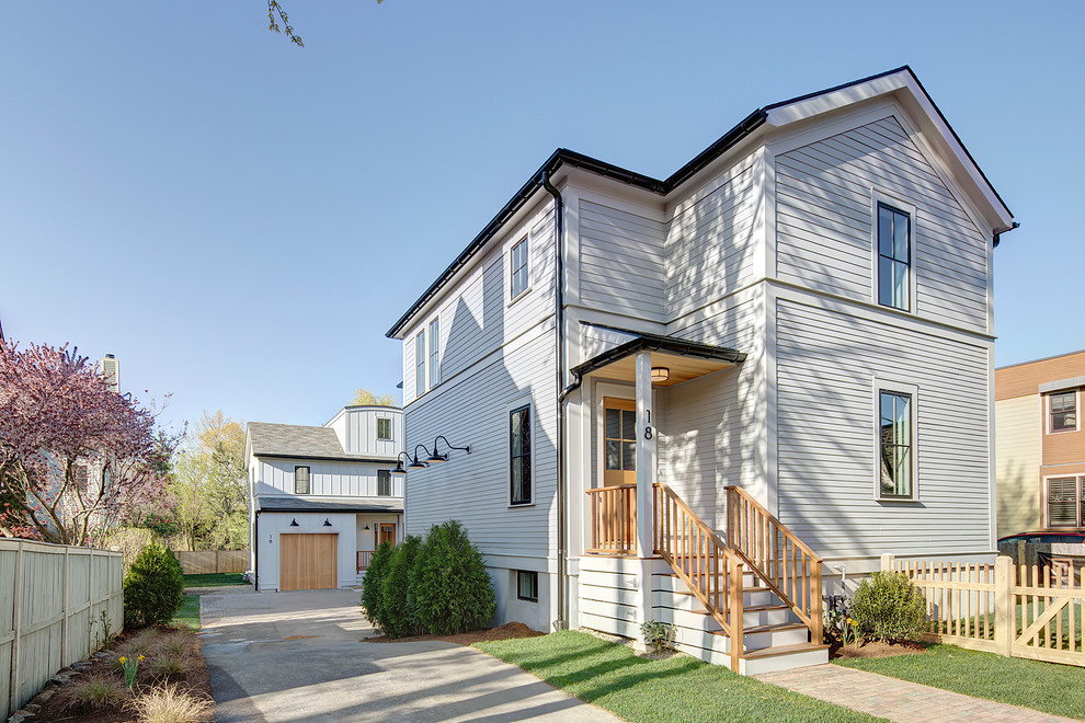 Inspiration for a mid-sized contemporary white two-story wood gable roof remodel in Boston
