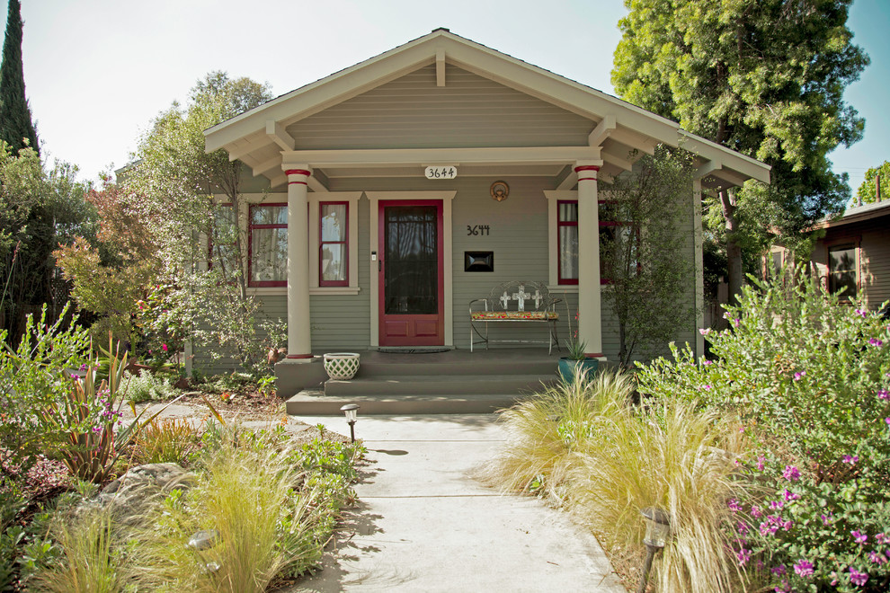Modelo de fachada de casa verde de estilo americano pequeña de una planta con revestimiento de madera
