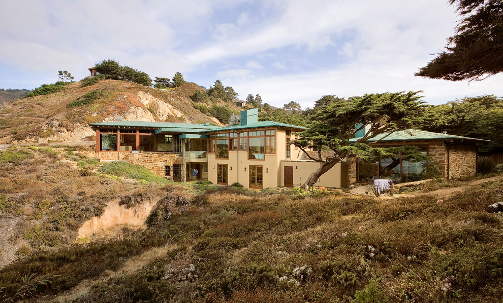 This is an example of a beach style house exterior in San Francisco with stone cladding.