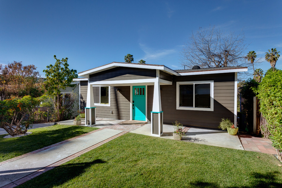 Medium sized and brown contemporary bungalow detached house in Los Angeles with wood cladding, a pitched roof and a shingle roof.