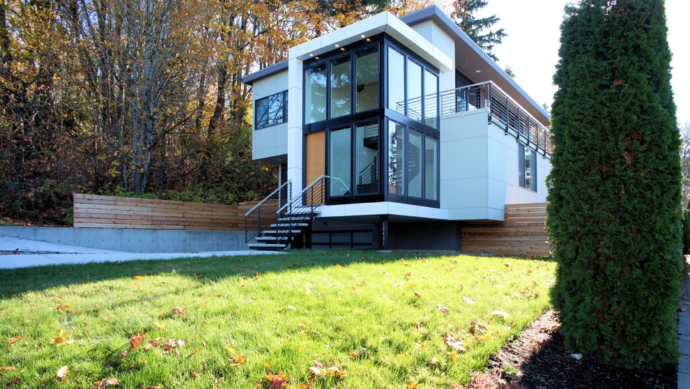 Inspiration for a medium sized and white modern two floor detached house in Seattle with mixed cladding and a flat roof.