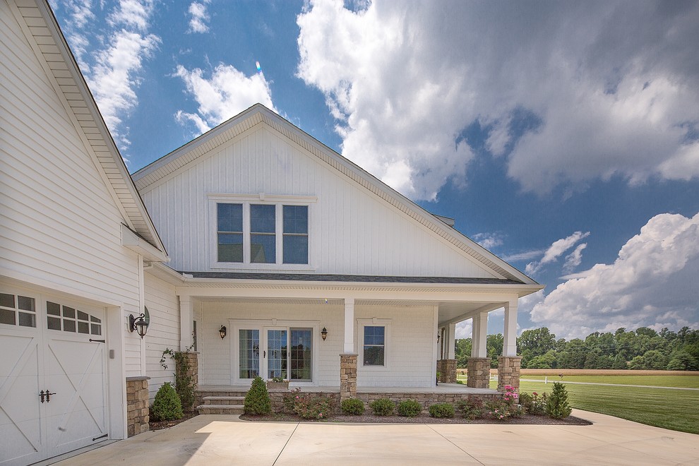 Example of a mid-sized arts and crafts white two-story vinyl gable roof design in Other