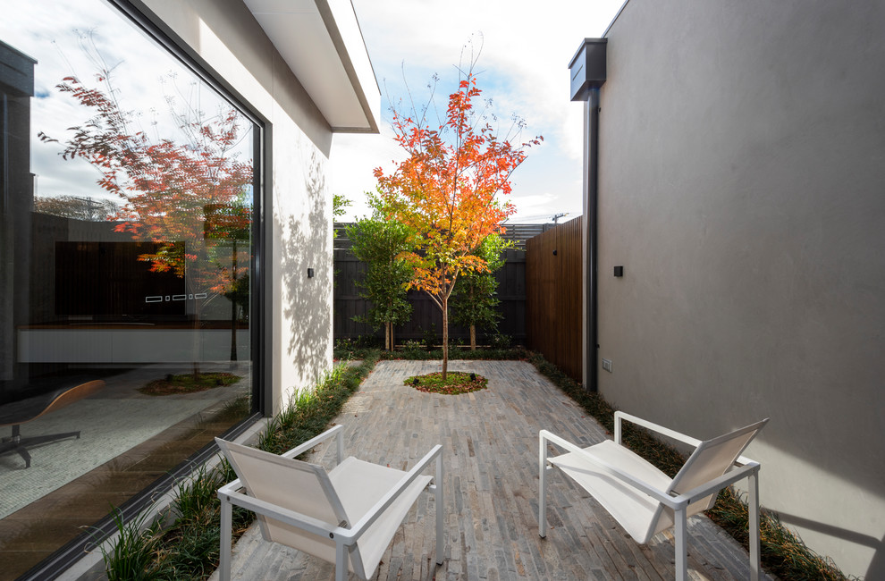 Inspiration for a contemporary gray two-story exterior home remodel in Melbourne