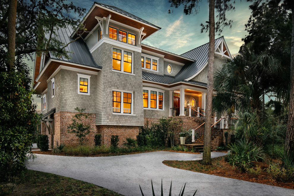 Inspiration for a gray two-story house exterior remodel in Charleston with a hip roof and a metal roof