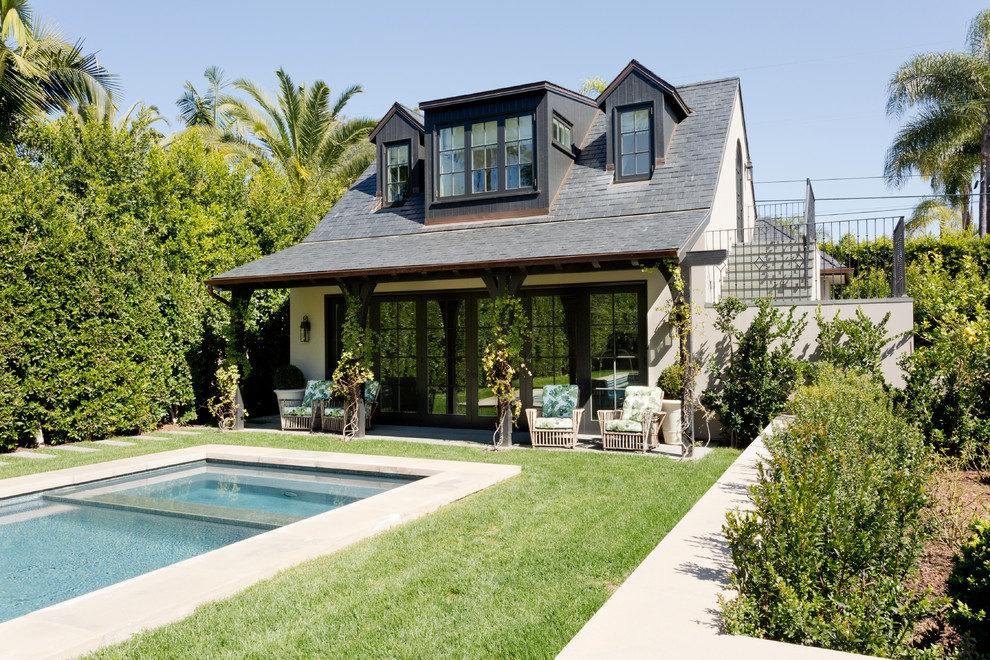 Elegant white two-story exterior home photo in Los Angeles with a shingle roof