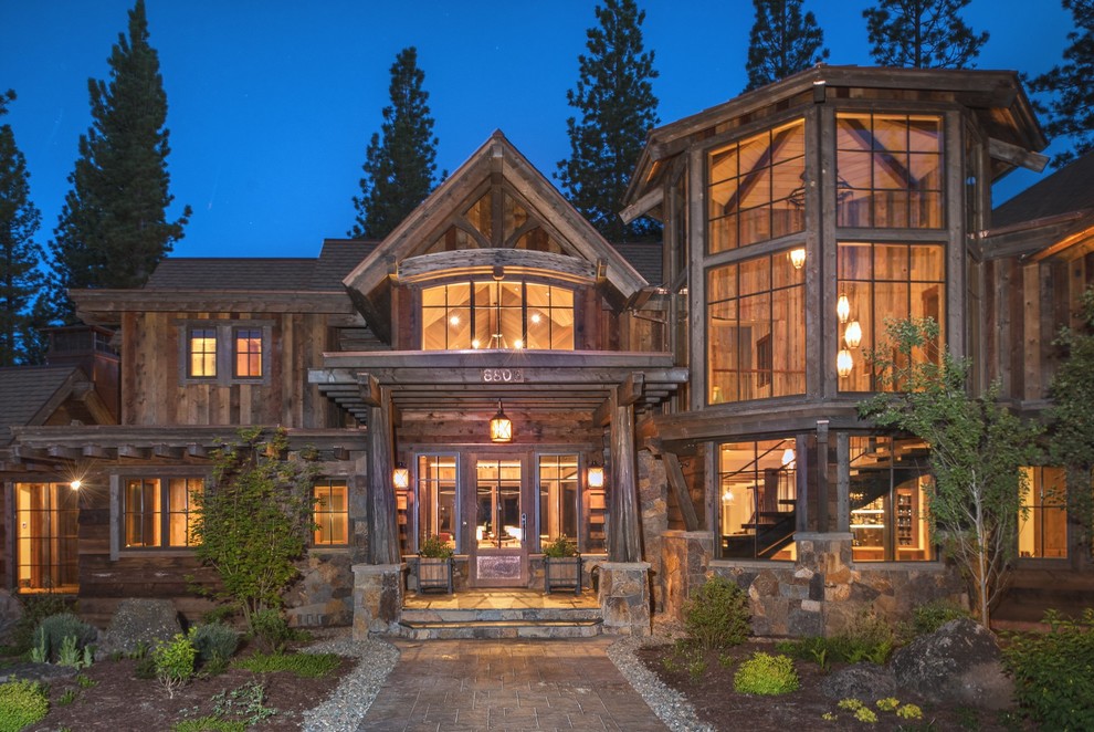 Photo of an expansive rustic two floor house exterior in Sacramento with wood cladding.