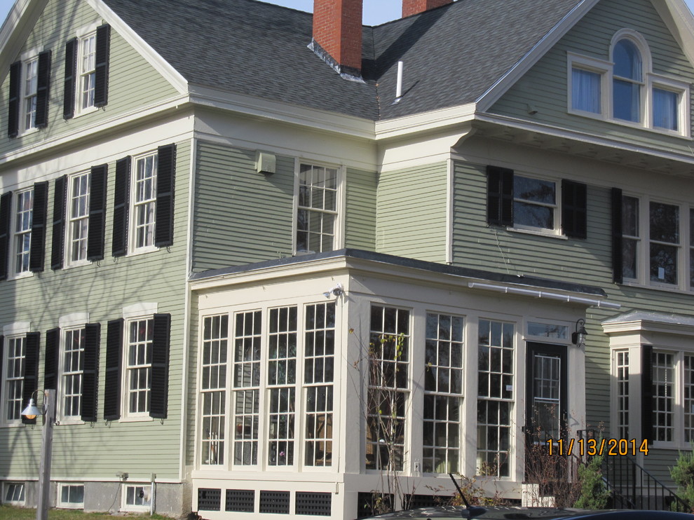 Photo of a large and green rural house exterior in Portland Maine with three floors and wood cladding.
