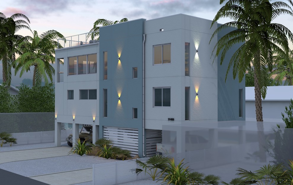Cette image montre une grande façade de maison blanche minimaliste à deux étages et plus avec un toit plat.