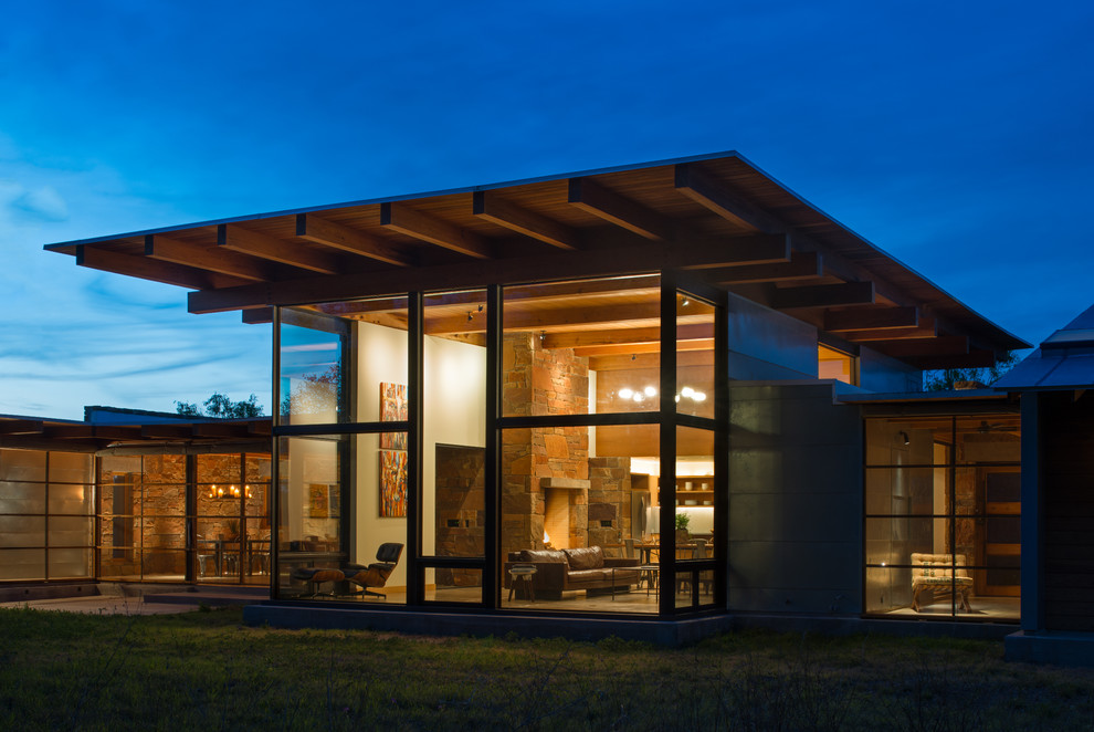 Diseño de fachada de casa multicolor minimalista grande de una planta con revestimiento de vidrio y tejado de un solo tendido