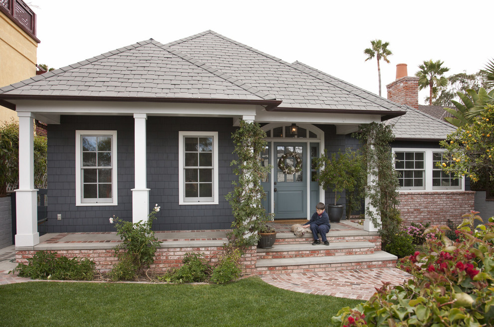 Photo of a medium sized and blue traditional bungalow house exterior in San Diego with wood cladding and a hip roof.