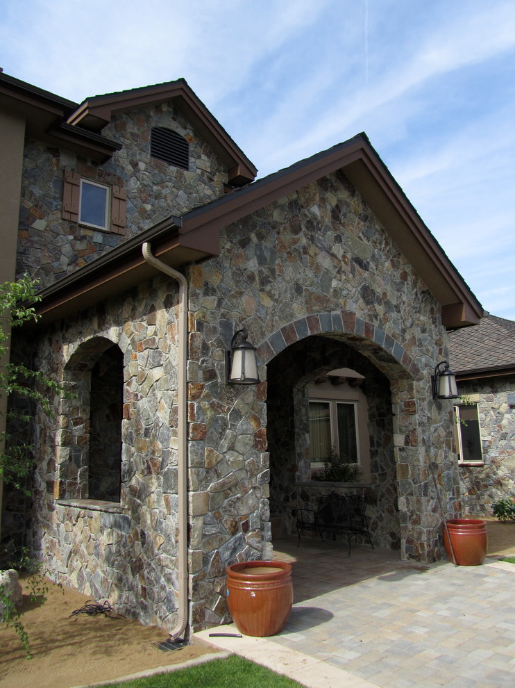 Inspiration for a classic house exterior in Other with stone cladding.