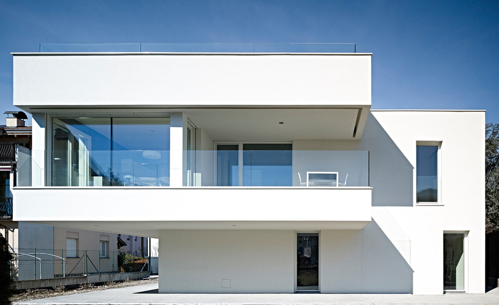 Foto de fachada blanca minimalista de tres plantas