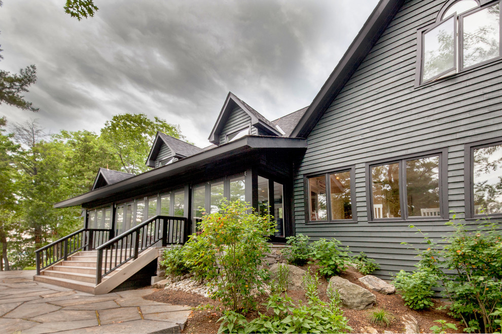 Photo of a black and medium sized classic detached house in Toronto with wood cladding.