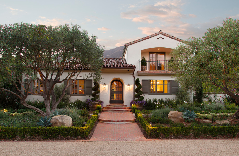 White mediterranean two floor house exterior in Santa Barbara with a tiled roof.