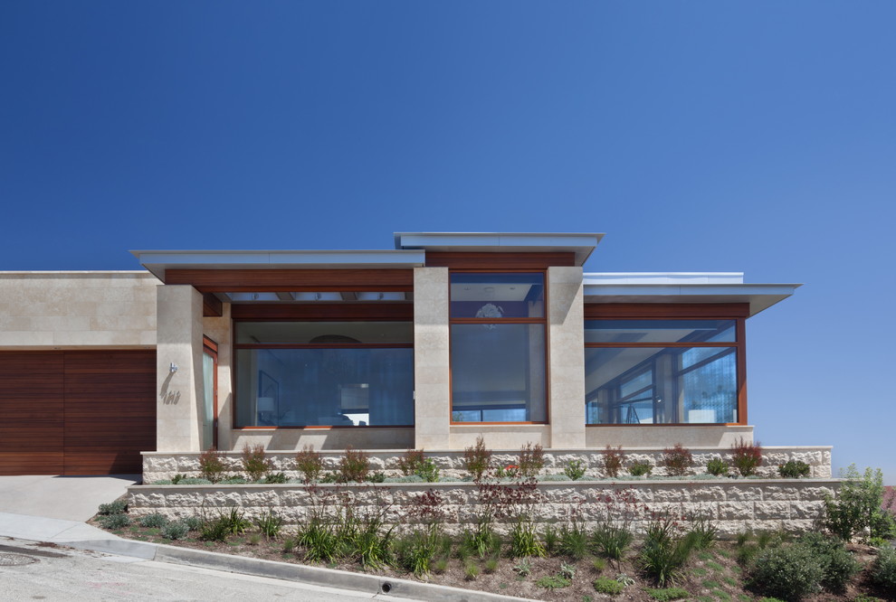 Идея дизайна: большой, одноэтажный, бежевый дом в стиле неоклассика (современная классика) с плоской крышей и облицовкой из камня