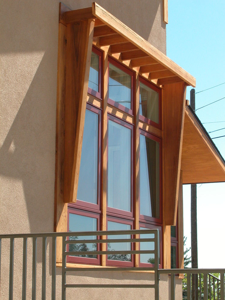 Example of a mid-sized transitional two-story stucco exterior home design in Denver