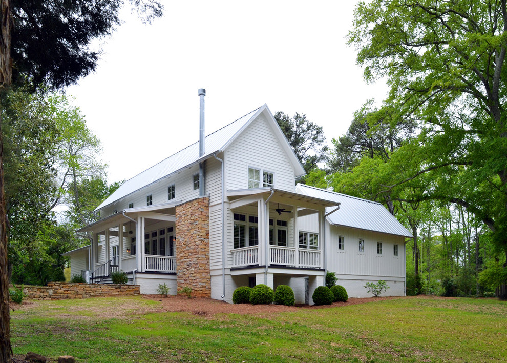 Inspiration for a mid-sized contemporary white two-story wood gable roof remodel in Birmingham