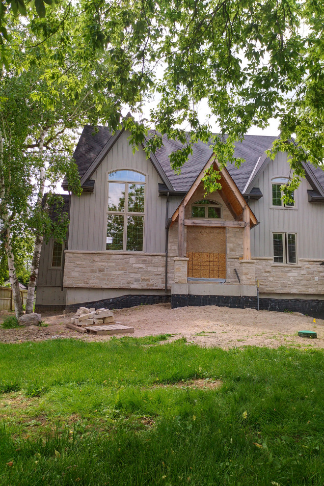 Modelo de fachada de casa gris clásica de dos plantas con revestimiento de madera y tejado de teja de madera