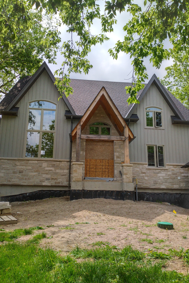 Inspiration pour une façade de maison grise traditionnelle en bois à un étage avec un toit en shingle.