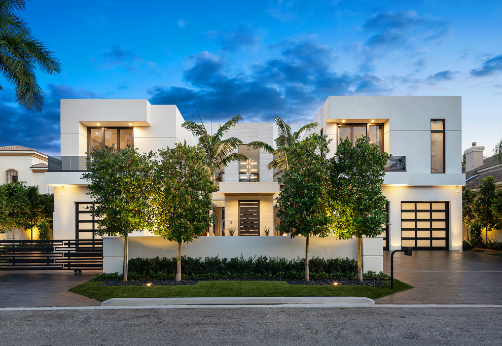 Large minimalist white two-story stucco exterior home photo in Miami