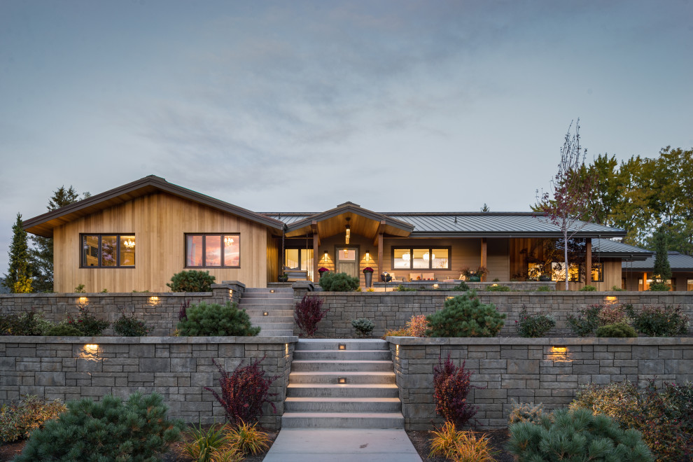 Example of a mid-sized mid-century modern brown one-story wood exterior home design in Boise with a metal roof