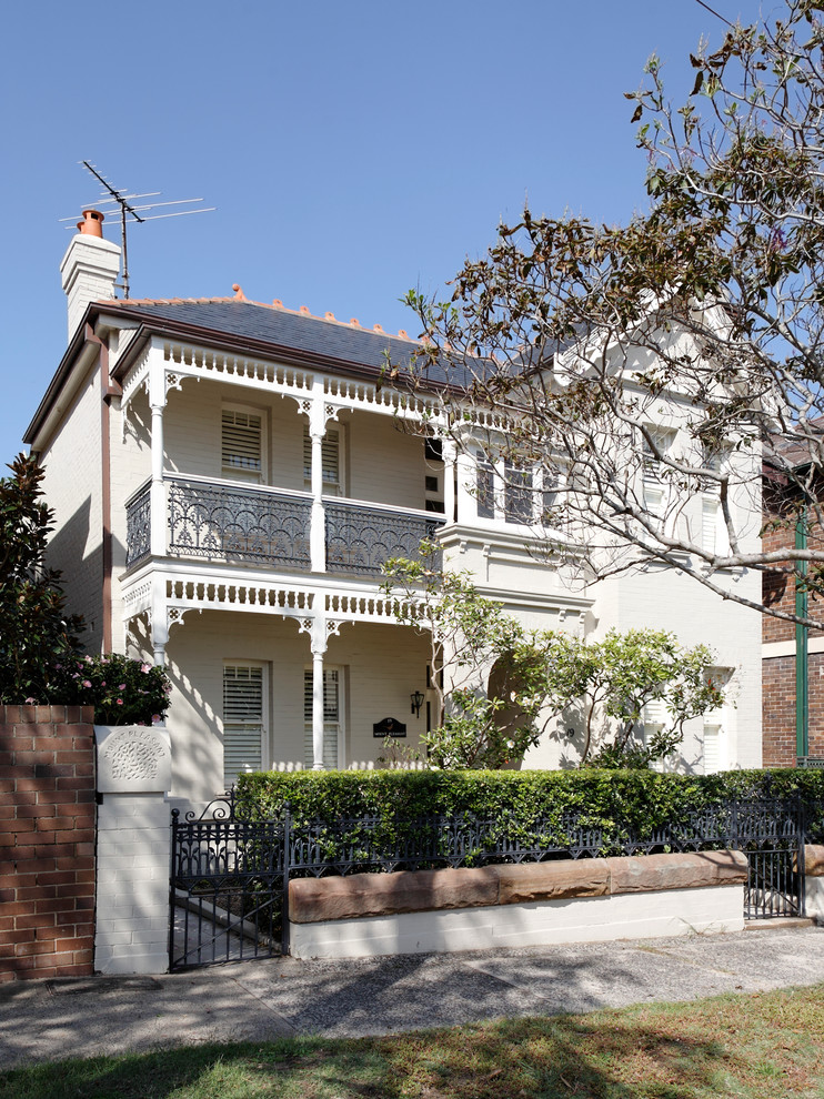 Large traditional white two-story stucco gable roof idea in Sydney