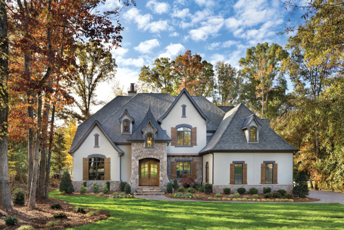 Example of a large transitional two-story exterior home design in Cincinnati with a hip roof