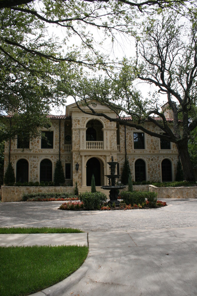 Inspiration for a timeless beige two-story stone exterior home remodel in Dallas