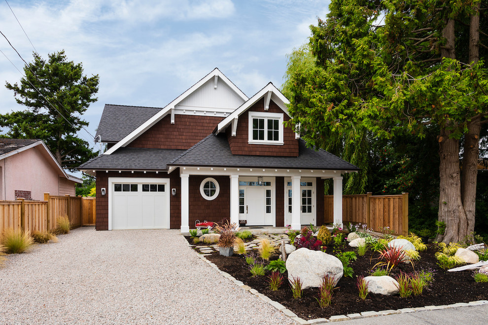 Example of a mid-sized mountain style brown two-story wood exterior home design in Vancouver with a shingle roof
