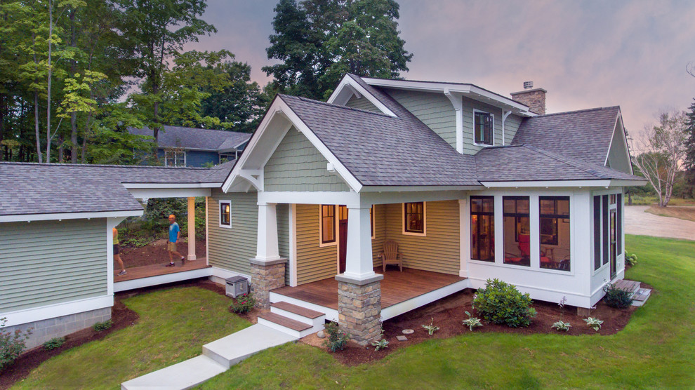 Example of an arts and crafts two-story house exterior design in Other with a shingle roof