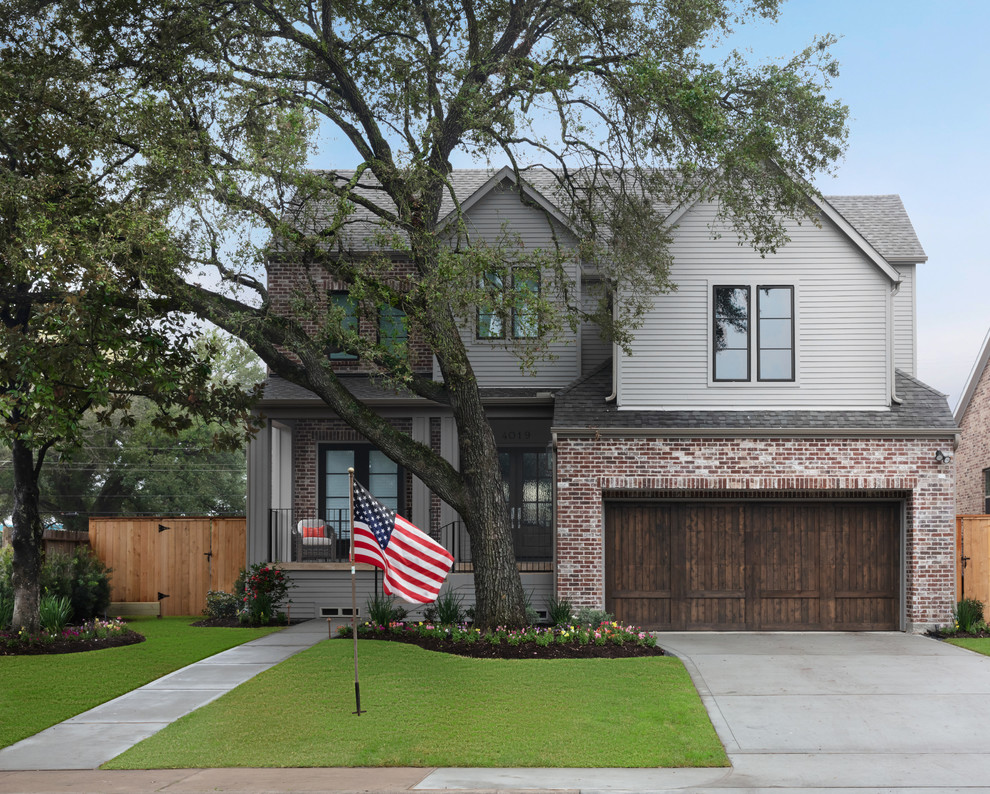 Traditional gray two-story exterior home idea in Houston with a shingle roof