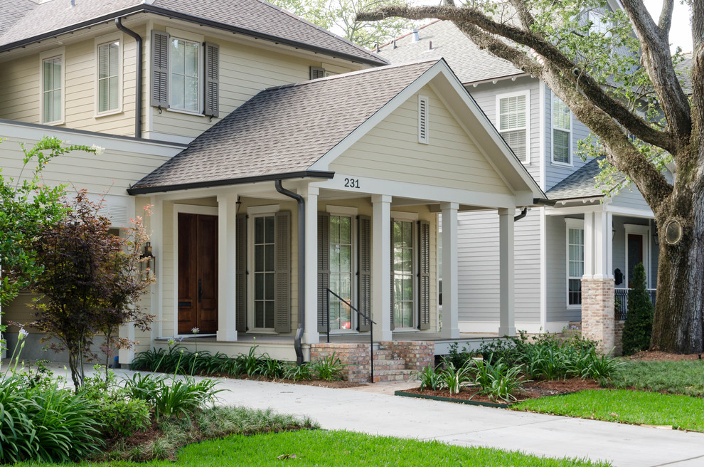 Large traditional beige two-story concrete fiberboard gable roof idea in New Orleans