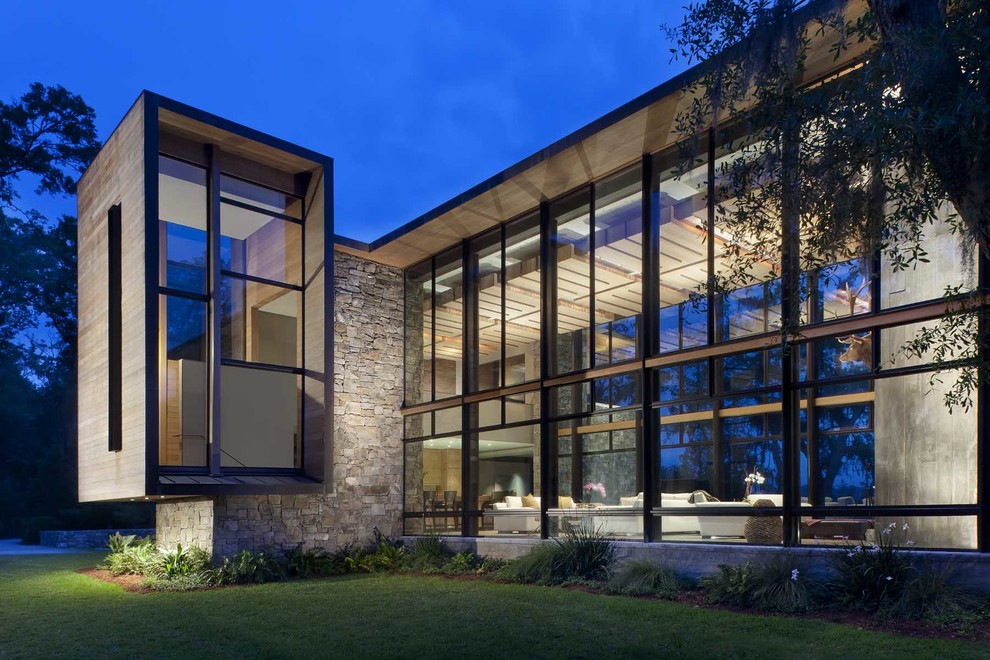 Inspiration for a large contemporary house exterior in Atlanta with stone cladding and a flat roof.