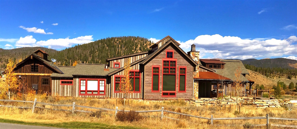 Large and gey rustic two floor house exterior in Denver with wood cladding and a pitched roof.