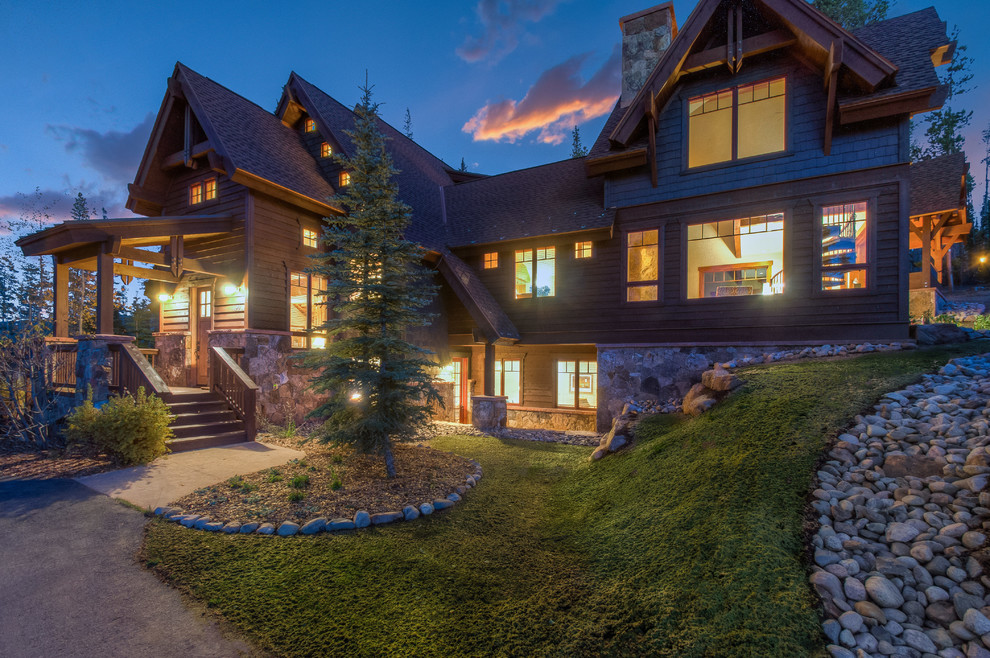 Large mountain style brown three-story wood exterior home photo in Denver with a mixed material roof