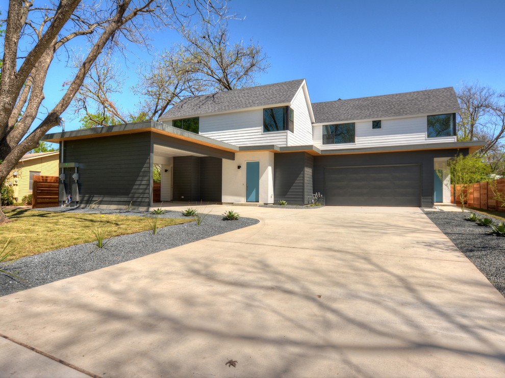 Mid-sized minimalist gray two-story concrete fiberboard exterior home photo in Austin with a shingle roof