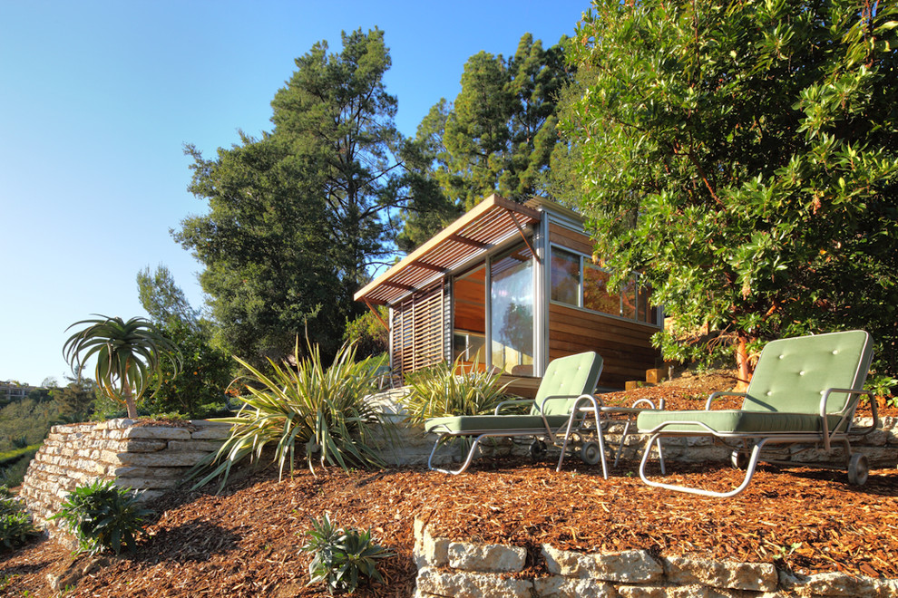 На фото: маленький, одноэтажный, деревянный дом в стиле модернизм для на участке и в саду