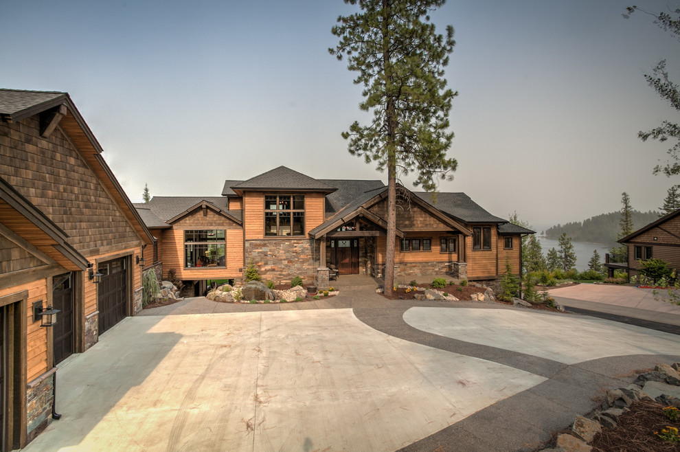 Example of a large mountain style brown three-story wood exterior home design in Seattle