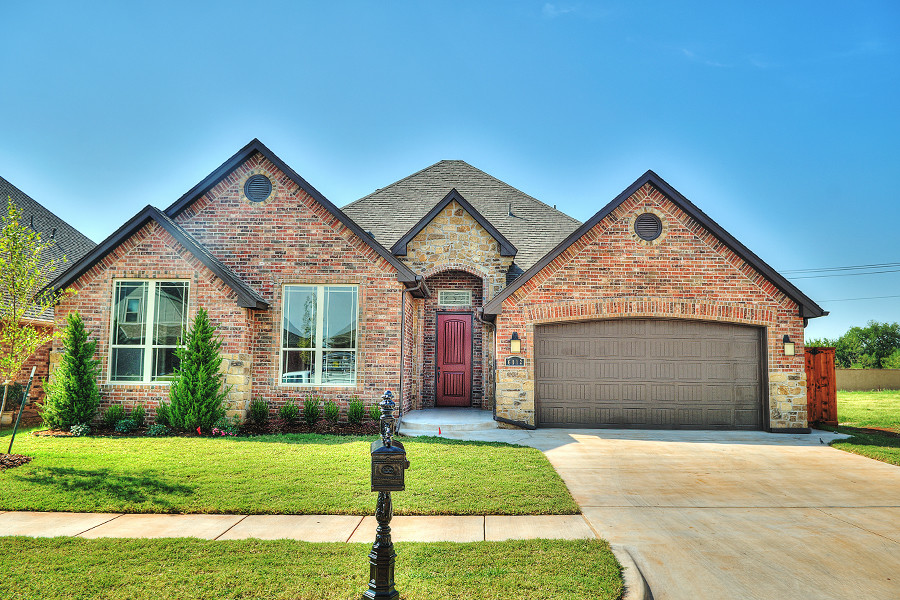 Mid-sized elegant red one-story brick gable roof photo in Oklahoma City