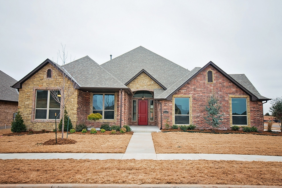 Design ideas for a large and red classic bungalow brick house exterior in Oklahoma City.