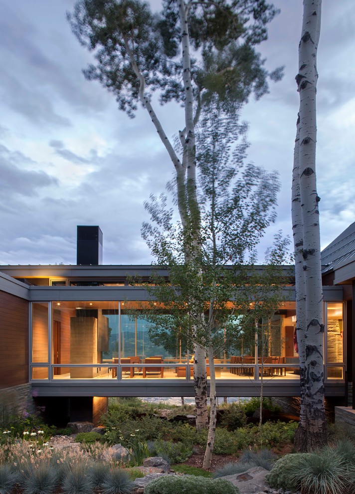 Inspiration for a contemporary bungalow glass house exterior in Denver.