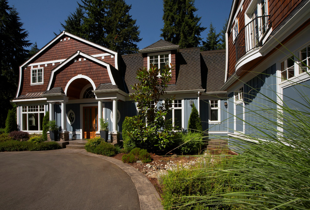 Inspiration for a timeless two-story exterior home remodel in Seattle with a gambrel roof