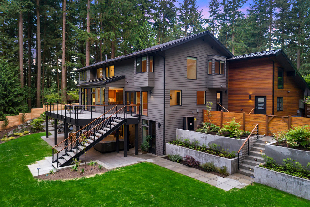 Design ideas for a multi-coloured contemporary detached house in Seattle with three floors, wood cladding, a lean-to roof and a metal roof.
